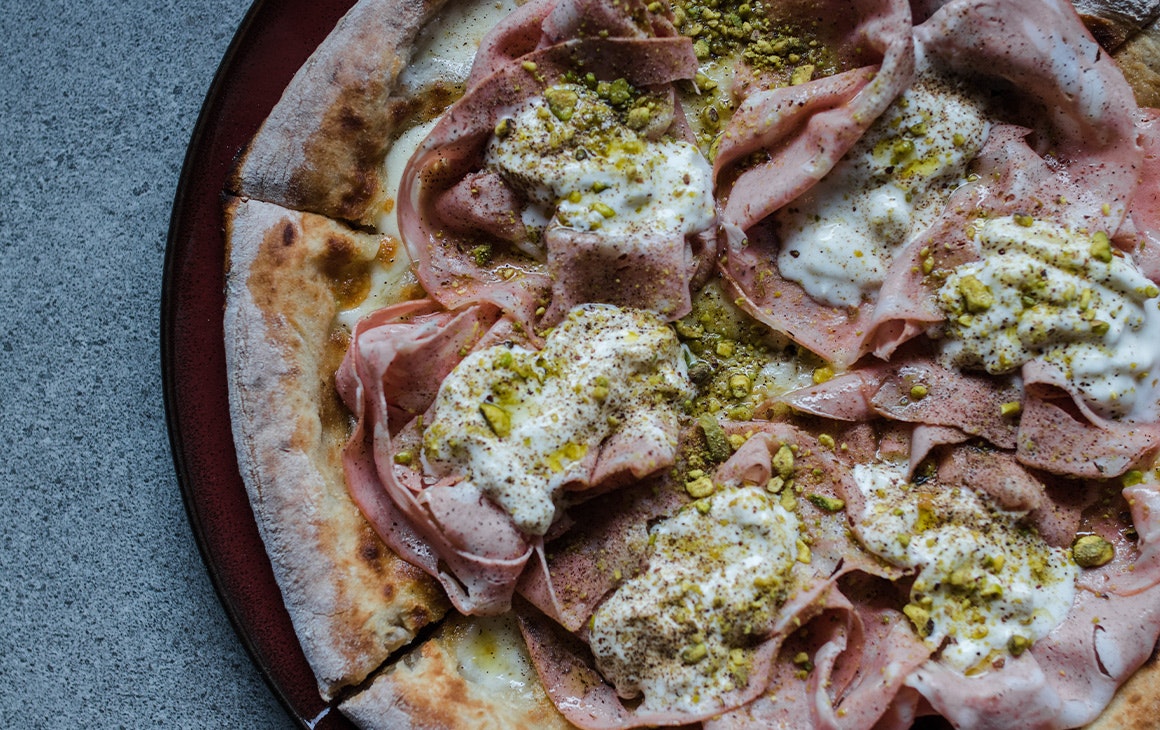 a pizza with mortadella and stracciatella